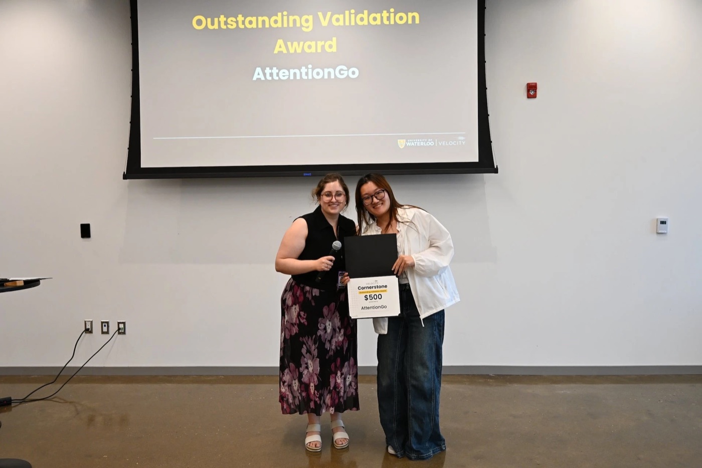 Bella Chen receiving the Velocity Cornerstone Outstanding Validation Award for AttentionGo