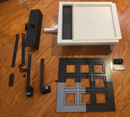 Prototype parts of the sound-to-marbling probe: a 3D-printed tray, a servo-driven arm, and a nine-cell grid